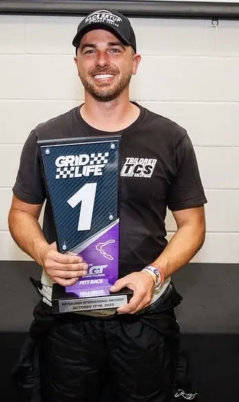 Chris DeLucia holding a first-place GRIDLIFE trophy