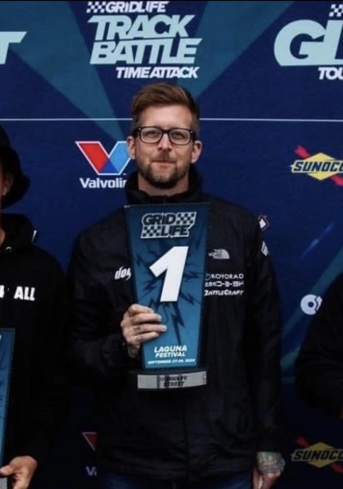 Will Drees holding a first-place GRIDLIFE TrackBattle trophy